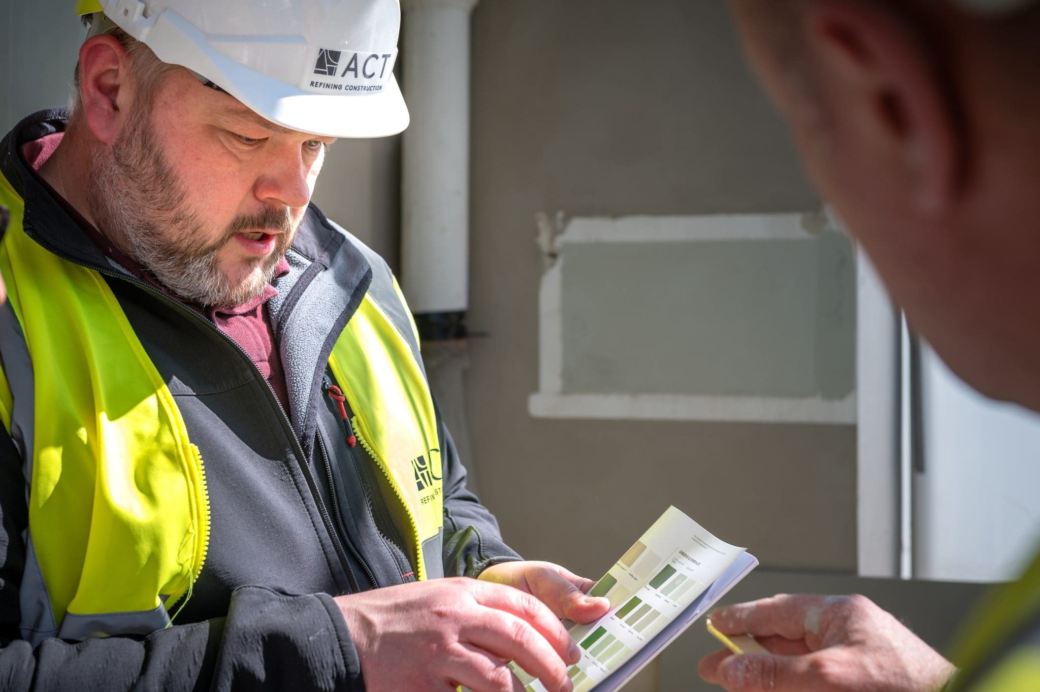 Subcontractor collaboration as ACT reviews colour swatches to align on design and finish quality.